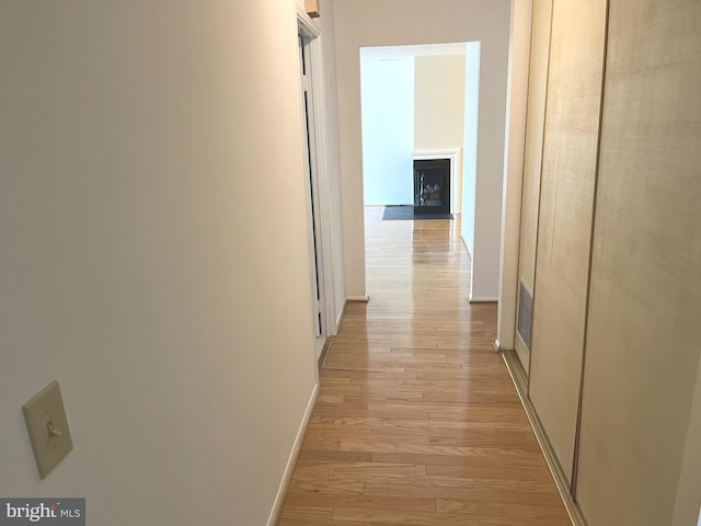 corridor with light hardwood / wood-style floors