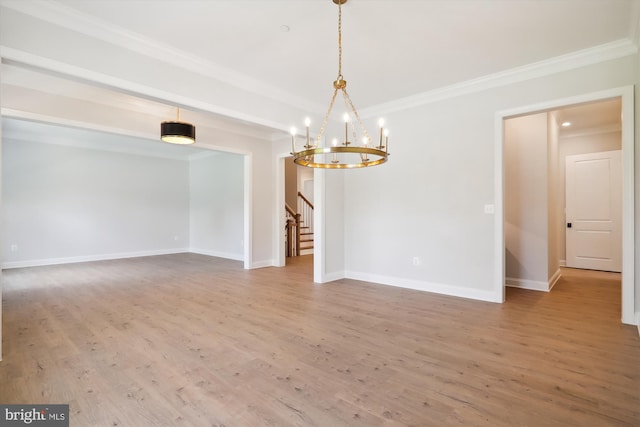 unfurnished dining area featuring a notable chandelier, ornamental molding, and hardwood / wood-style flooring