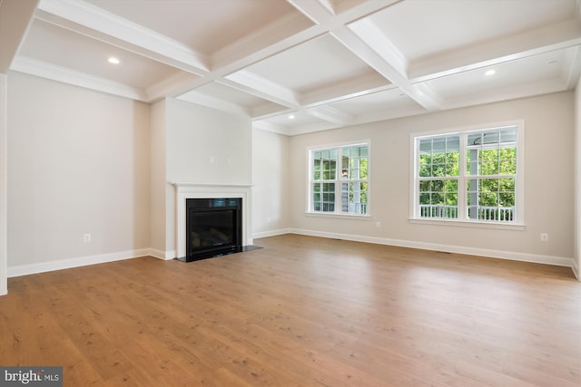 unfurnished living room featuring coffered ceiling, beamed ceiling, and hardwood / wood-style flooring