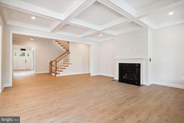 unfurnished living room featuring light wood-type flooring, coffered ceiling, crown molding, and beamed ceiling