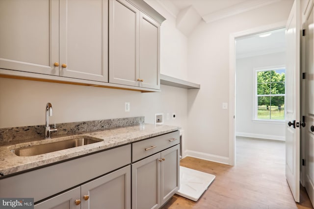 laundry room featuring cabinets, hookup for a washing machine, crown molding, electric dryer hookup, and sink