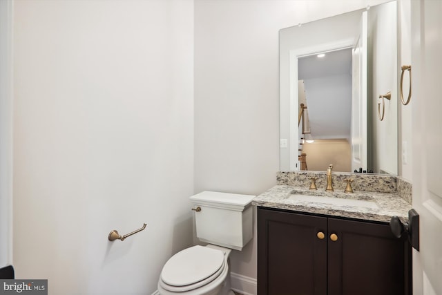 bathroom featuring toilet and vanity