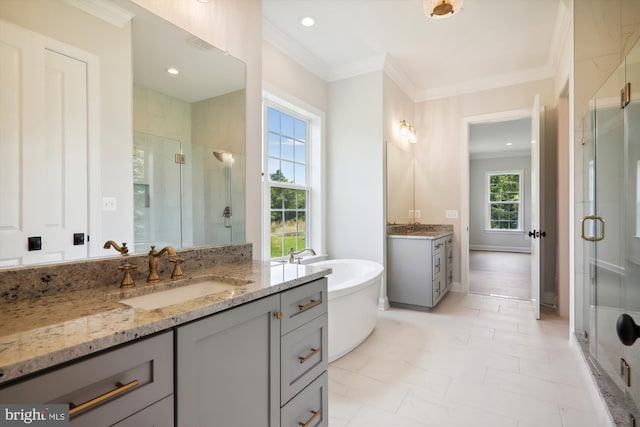 bathroom with vanity, crown molding, and plus walk in shower