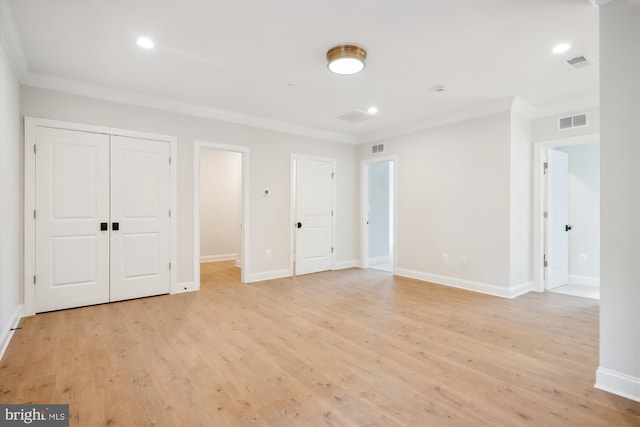 unfurnished bedroom featuring ornamental molding and light wood-type flooring