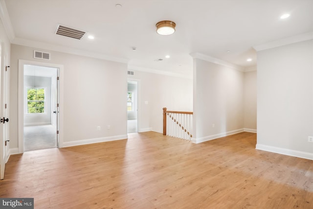 unfurnished room featuring crown molding and light hardwood / wood-style flooring