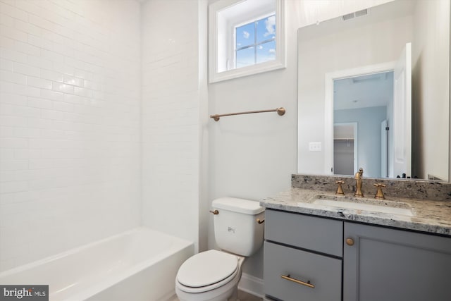 full bathroom with toilet, vanity, and washtub / shower combination