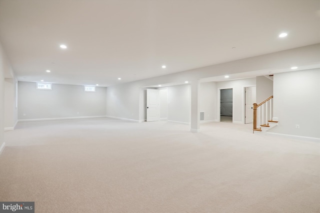 basement featuring light carpet