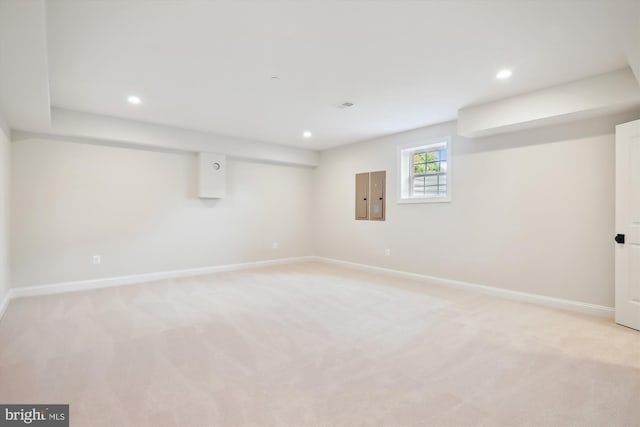 basement featuring light carpet