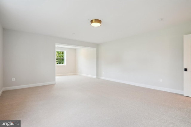 unfurnished room with light colored carpet