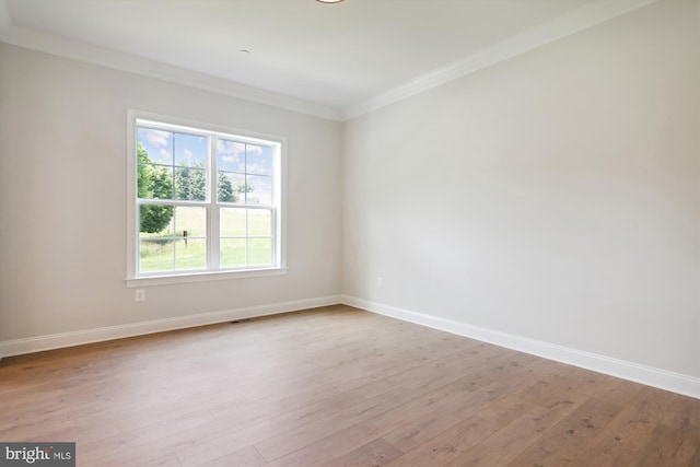 unfurnished room featuring ornamental molding and light hardwood / wood-style floors