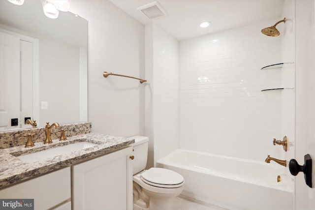 full bathroom featuring tiled shower / bath, vanity, and toilet