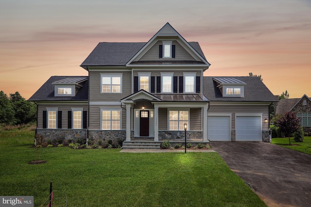 craftsman house with a yard and a garage