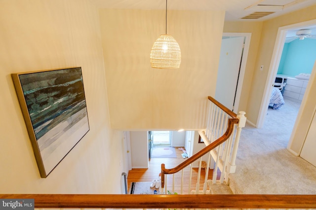 stairs featuring carpet and a notable chandelier