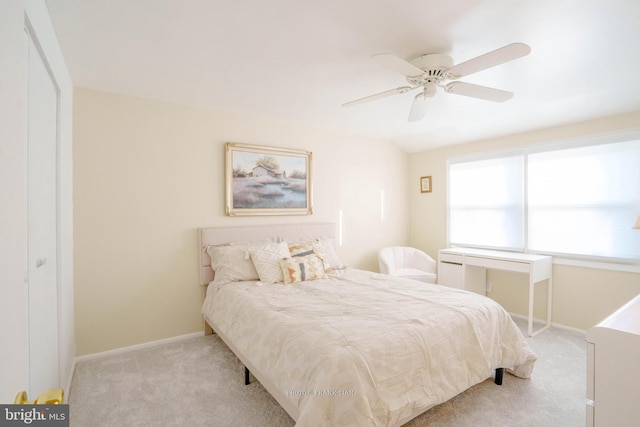 carpeted bedroom with ceiling fan and a closet