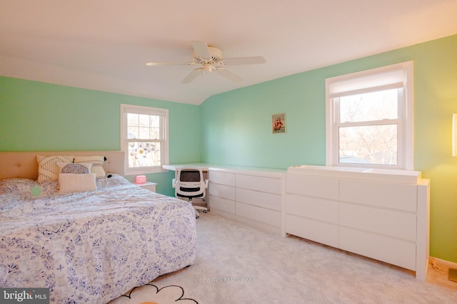 carpeted bedroom with multiple windows and ceiling fan