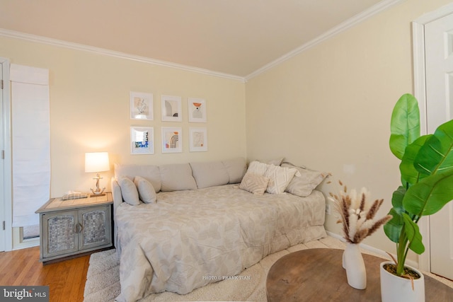 bedroom featuring wood-type flooring and ornamental molding