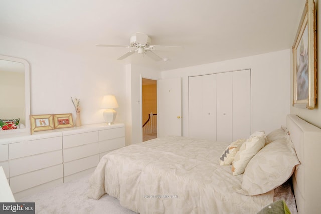 carpeted bedroom with a closet and ceiling fan