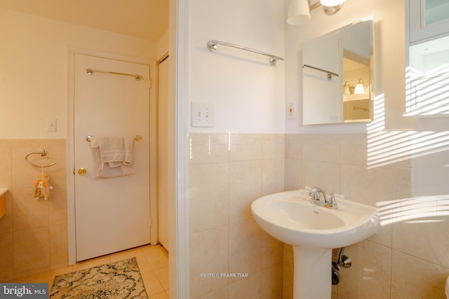 bathroom with tile patterned floors and tile walls