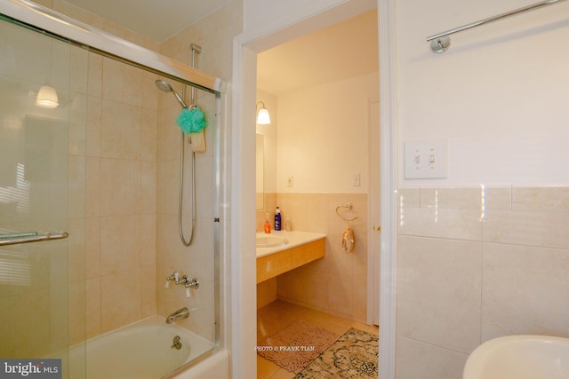 bathroom featuring tiled shower / bath combo, tile patterned floors, and tile walls