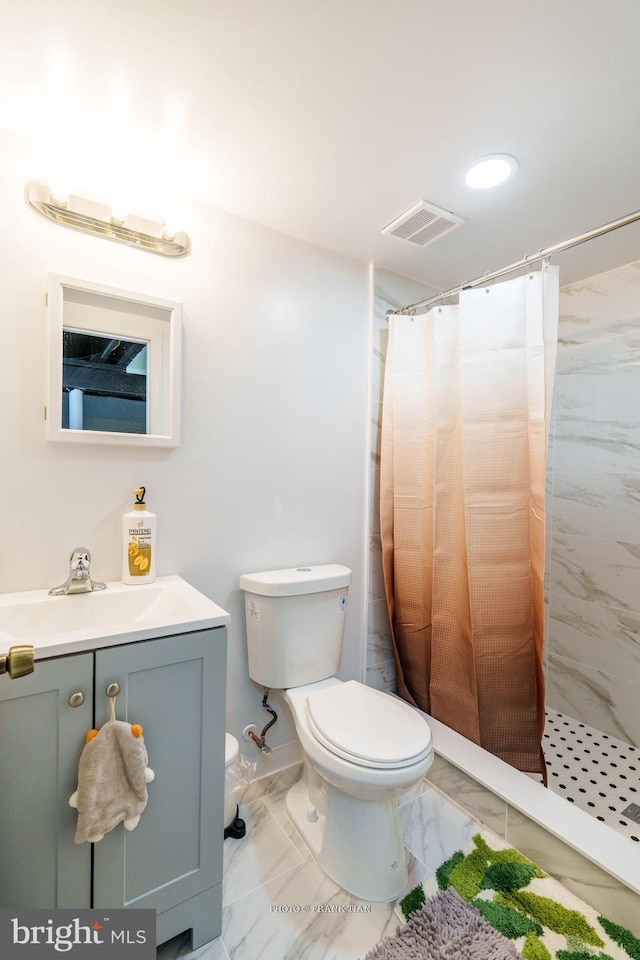 bathroom featuring toilet, vanity, and walk in shower