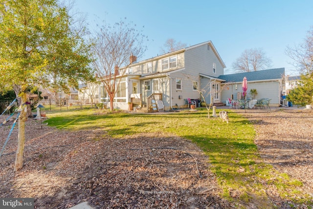 rear view of property featuring a lawn and a patio