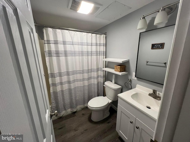 bathroom featuring toilet, oversized vanity, and hardwood / wood-style floors