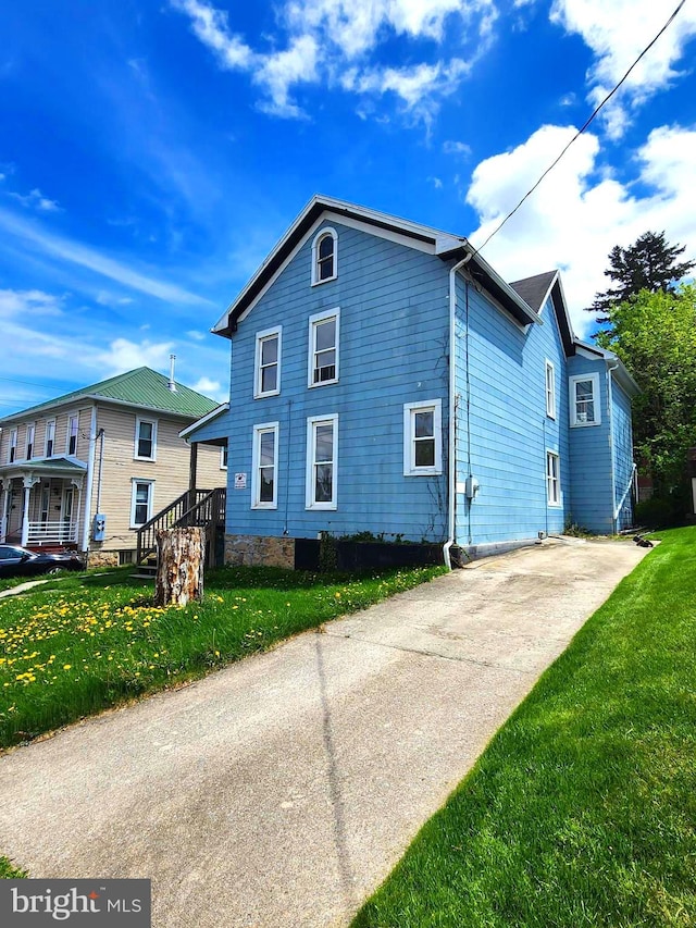 view of side of home featuring a lawn