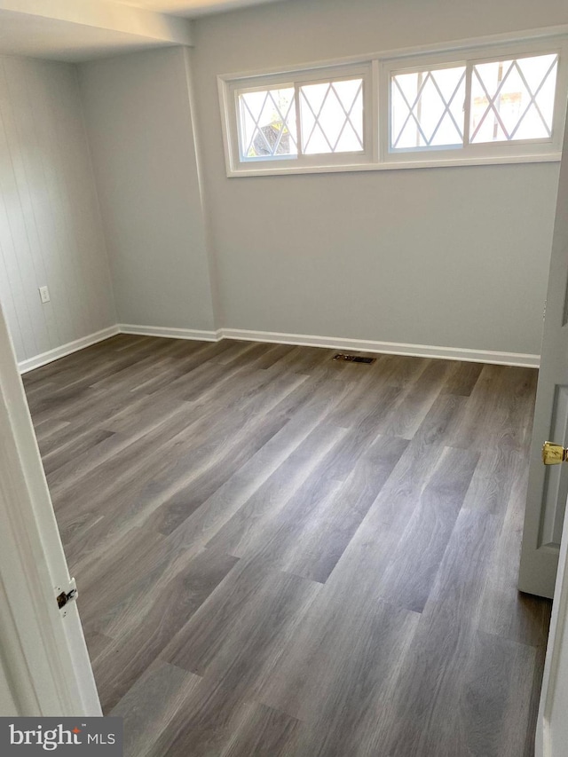 empty room featuring dark hardwood / wood-style flooring