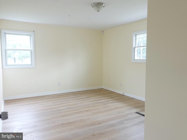 spare room with light hardwood / wood-style flooring