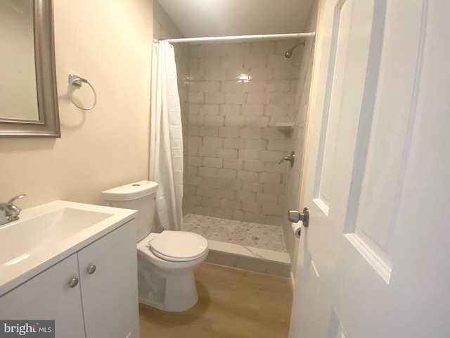 bathroom with a shower with shower curtain, vanity, toilet, and wood-type flooring