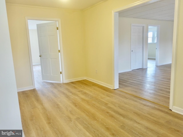 spare room with light hardwood / wood-style floors and ornamental molding