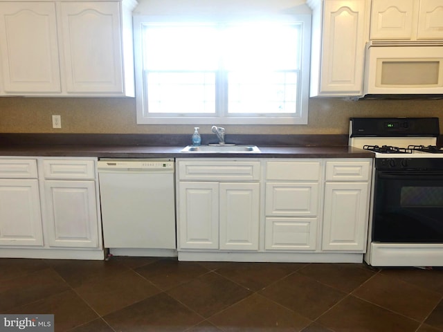 kitchen featuring white cabinets, white appliances, plenty of natural light, and sink