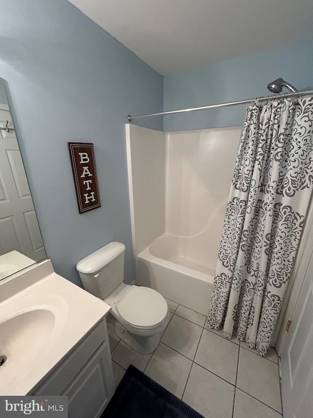 full bathroom with toilet, tile patterned flooring, vanity, and shower / tub combo with curtain