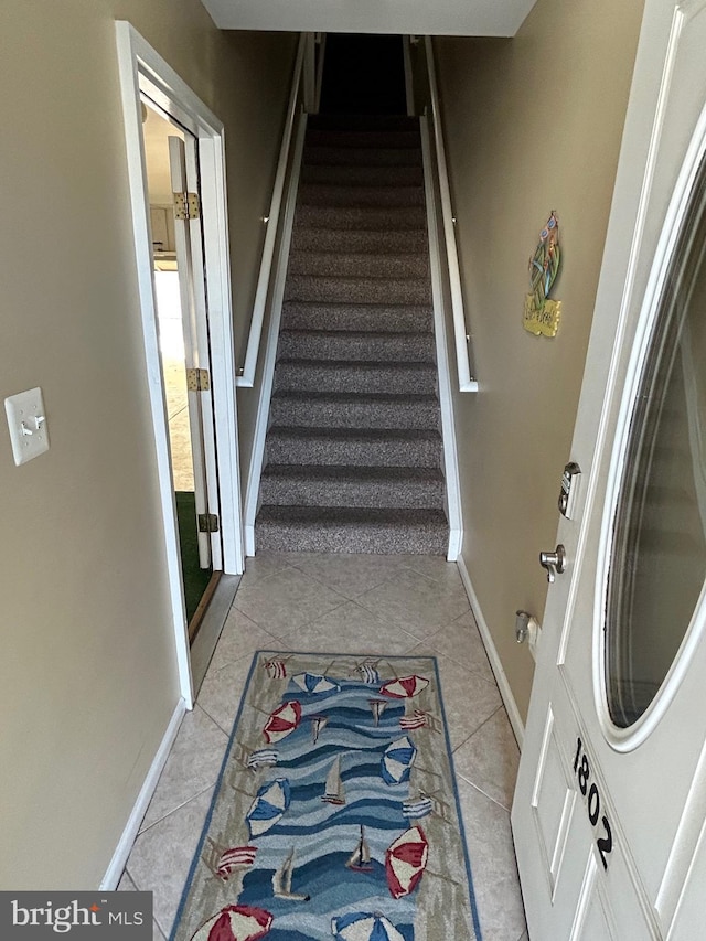 staircase with tile patterned floors