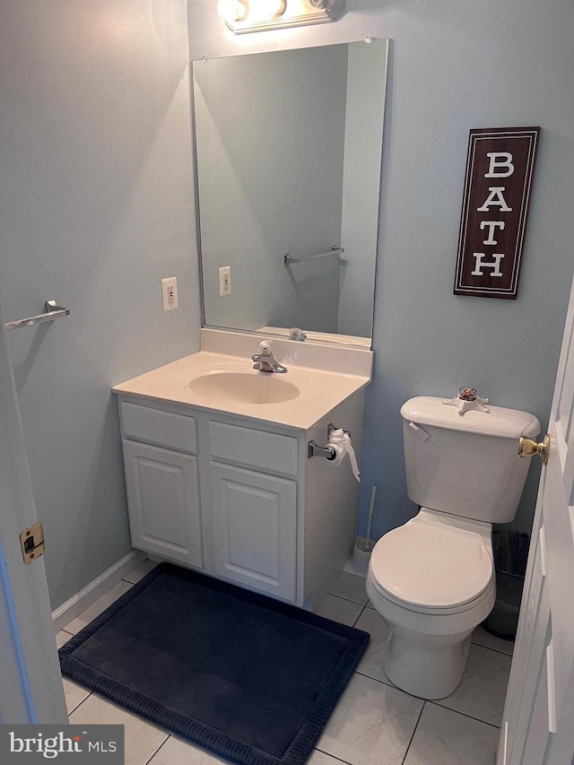 bathroom featuring tile patterned flooring, vanity, and toilet