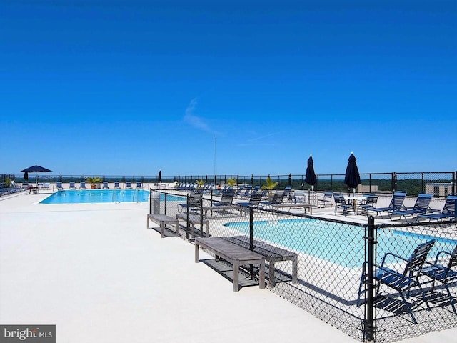 view of swimming pool with a patio