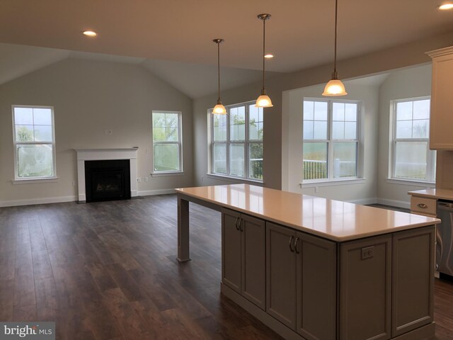 kitchen featuring decorative light fixtures, dark wood-type flooring, dishwasher, and a kitchen island