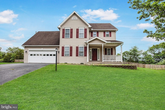 view of front of property with a garage, a front yard, and a porch