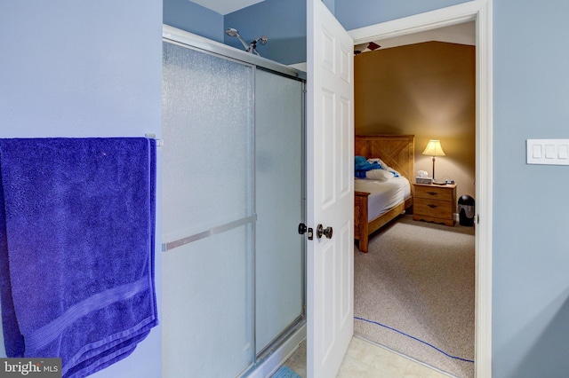 bathroom with an enclosed shower and tile floors