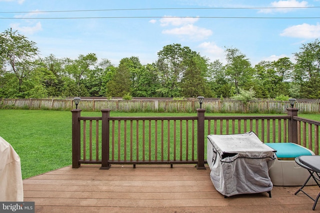 wooden deck with a lawn