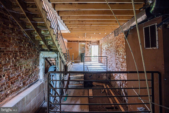 interior space featuring brick wall