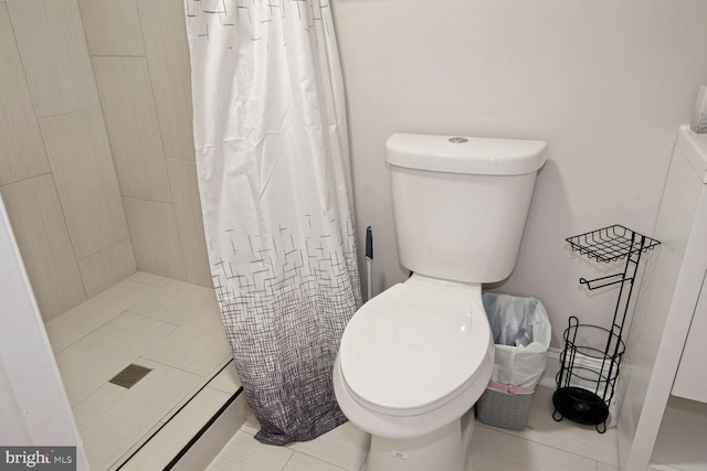 bathroom with toilet and a shower with shower curtain