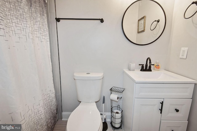 bathroom featuring toilet, a shower with curtain, and vanity