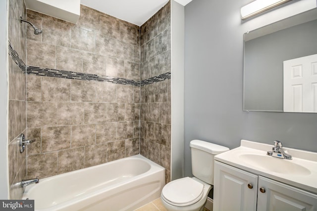 full bathroom featuring tiled shower / bath combo, vanity, and toilet