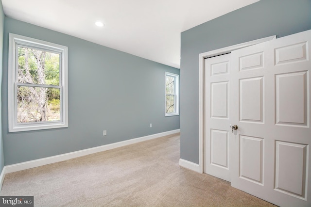 unfurnished bedroom featuring light colored carpet