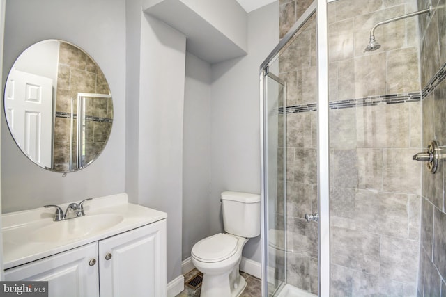 bathroom featuring walk in shower, oversized vanity, and toilet