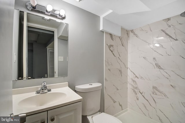 bathroom with vanity with extensive cabinet space and toilet