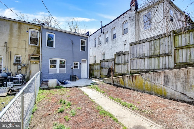 rear view of property featuring central AC unit