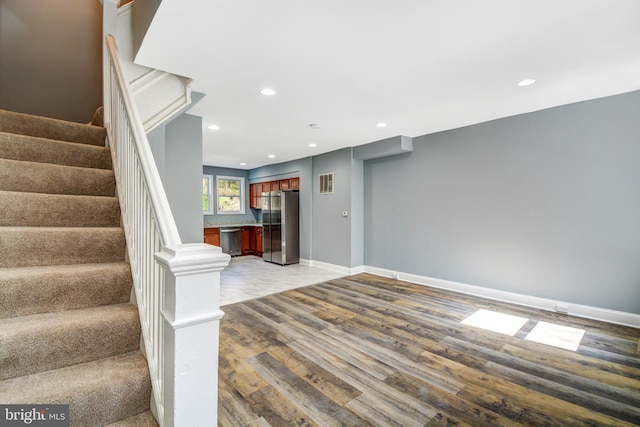 stairs featuring hardwood / wood-style floors