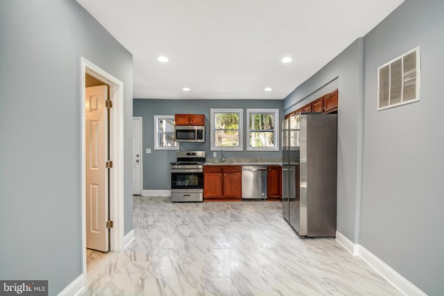 kitchen with light tile floors and stainless steel appliances